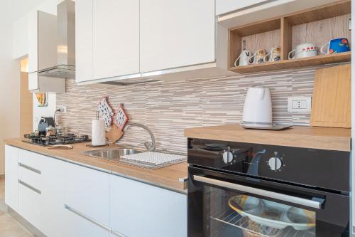 a kitchen with a sink and a stove top oven at Casa Alejandra a Pachino centro in Pachino