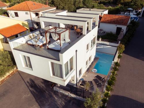 an aerial view of a white house with a swimming pool at Rooftop Spa in Trogir