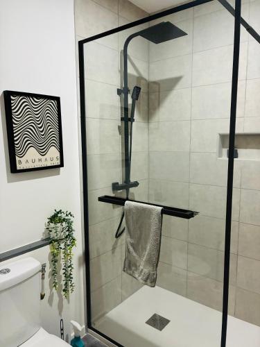 a shower with a glass door in a bathroom at Private riverside villa with breathtaking views in Axat