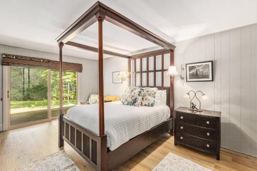a bedroom with a canopy bed and a window at Bright 4BDR Home by Lake MI Arcadia Bluffs Portage Lake More in Arcadia