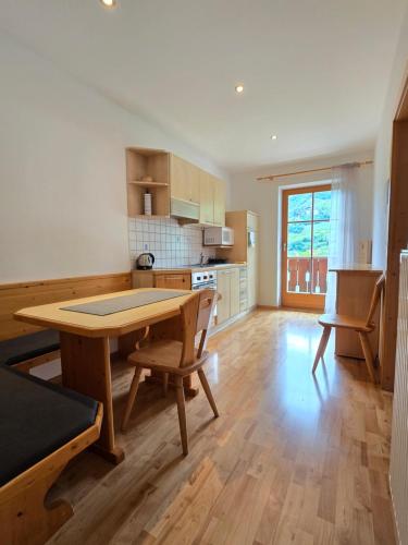 a kitchen with a table and chairs in a room at Martscholer Weinhof in Chiusa