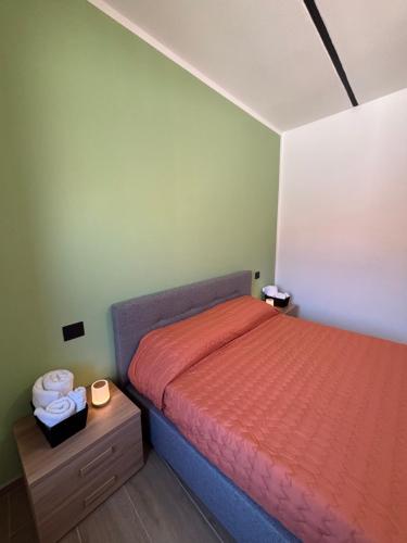 a small bedroom with a bed and a nightstand with a bed sidx sidx sidx at Cascina Barbei in Camerana 