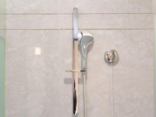 a shower with a shower head on a wall at Echarm Hotel Xiangyang Erqi in Xiangyang