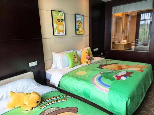 a bedroom with two beds with stuffed animals on them at Suzhou Qingshan Conference Center in Suzhou