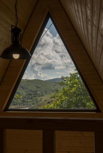 a window in a room with a view at Pinehouse Urtkhva in Surami 
