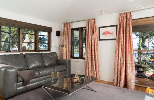 a living room with a couch and a table at Black Dolphin Inn in New Smyrna Beach