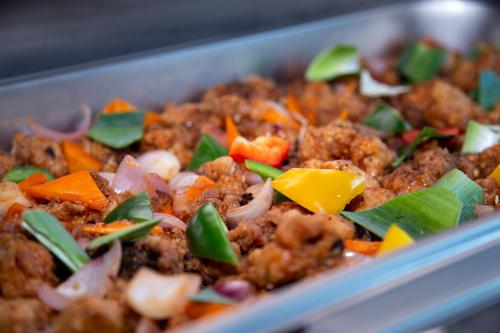 a dish of food with meat and vegetables at Hotel Silver Horse Dambulla in Dambulla