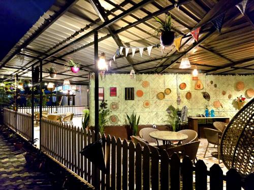 a restaurant with a table and chairs and a bar at The Gulmohar Inn in Guwahati