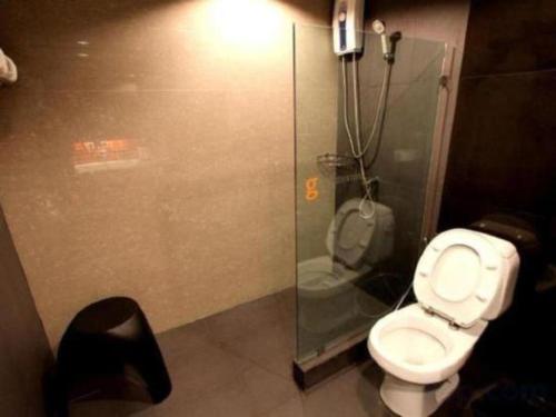 a bathroom with a toilet and a shower stall at The Regent Ubon in Ubon Ratchathani