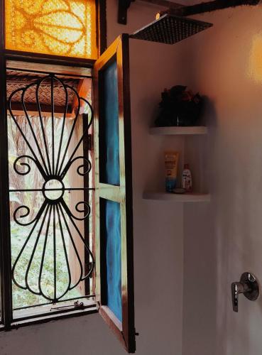 a stained glass window on a bathroom door at Laguna Palace Resort in Michamvi