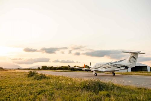 a small plane is sitting on a runway at Kapama Southern Camp in Kapama Private Game Reserve
