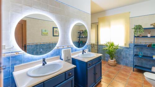 a bathroom with two sinks and a mirror at Casa Corazón 44 Torrox by Ruralidays in Torrox