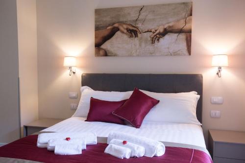 a bedroom with a bed with two towels on it at Leonardo Da Vinci Guest House in Rome