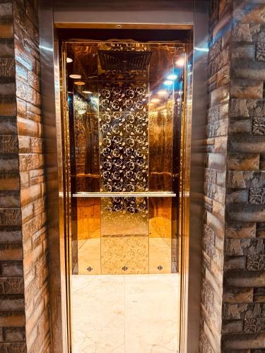 a glass door with a bunch of wine bottles at Hotel Wisteria Haridwar in Haridwār