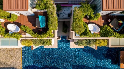 an overhead view of a swimming pool in a building at Let's Sea Hua Hin Al Fresco Resort in Hua Hin