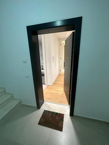 a mirror on the side of a room with a hallway at Blin B&B in Draçi