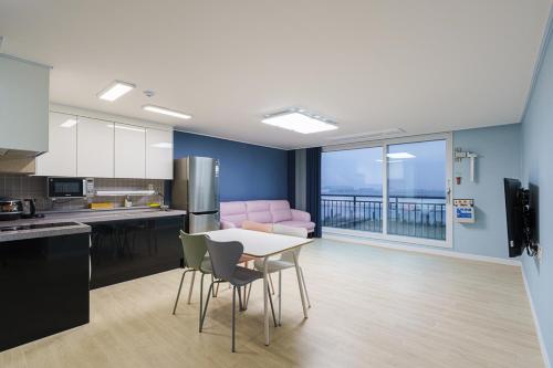 a kitchen with a table and chairs in a room at Little Prince Hotel&Condo in Gunsan