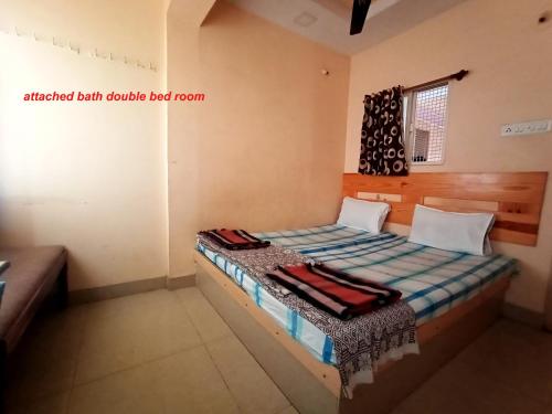 a small bedroom with a bed in a room at VRP Guest House in Bhuj