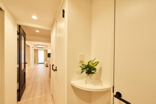 a bathroom with a sink and a plant on a counter at brand-new hotel, a 3-minute walk from Asakusa Kuramae Statio in Tokyo