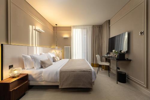 a hotel room with a bed and a desk at LUBICH Concept Hotel in Lviv