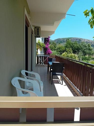 a balcony with chairs and a table and a view at Maria's home - Katelios in Katelios