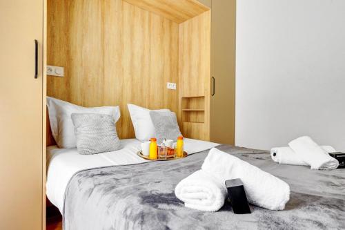 une chambre avec deux lits avec des serviettes dessus dans l'établissement 245 Suite Mercedes - Superb apartment in Paris, à Paris