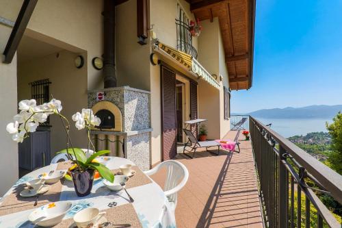 a balcony with a table with a vase of flowers on it at Casetta di Rosetta in Arizzano