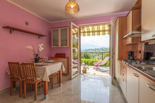 a kitchen and dining room with a table and a view at Casetta di Rosetta in Arizzano