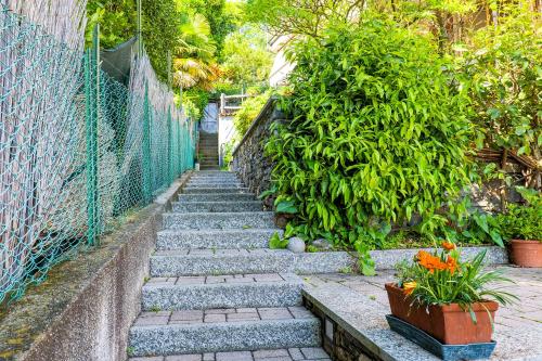 a set of stairs with plants and a fence at Casetta di Rosetta in Arizzano