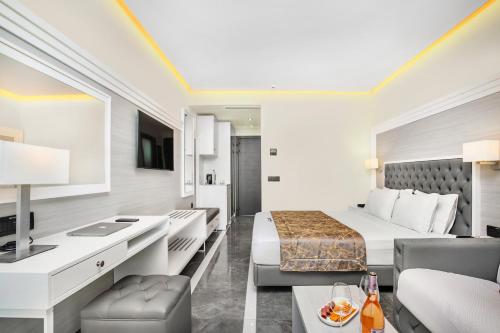 a hotel room with a bed and a living room at Bareti Boutique Estate in Kallithea Halkidikis