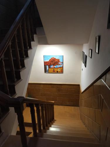 a staircase in a building with a painting on the wall at Jaisalmer Elite Castle in Jaisalmer