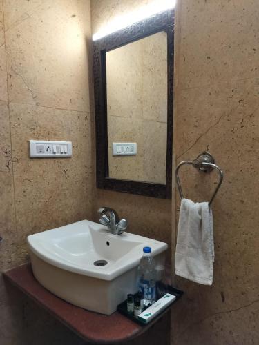 a bathroom with a sink and a mirror at Jaisalmer Elite Castle in Jaisalmer