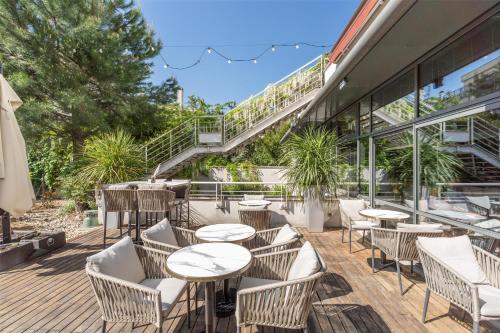 a patio with tables and chairs in front of a building at Radisson Blu Hotel, Paris Boulogne in Boulogne-Billancourt