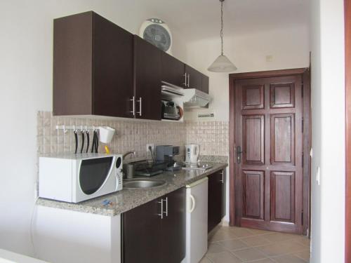 a kitchen with a microwave and a counter top at cabo dream 75 in Cabo Negro