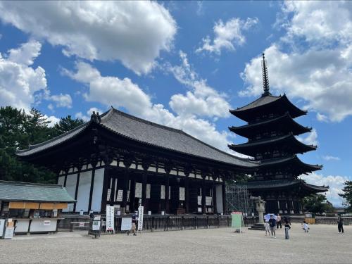 a large black and white building with a pagoda at Hotel Nikko Nara in Nara