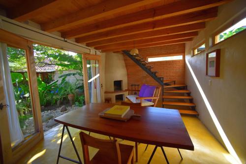 a room with a wooden table and a staircase at Las Casas Chiapas in San Cristóbal de Las Casas