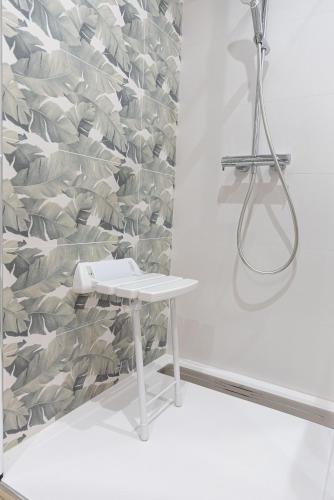 a white table in a room with a wall at SOLGUEST Aparthotel Estepona in Estepona