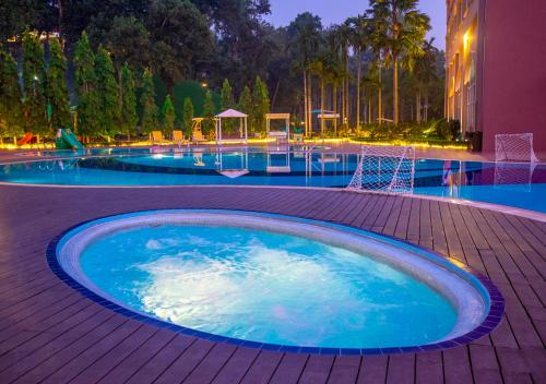 a large swimming pool at night with at Grand Sultan Tea Resort & Golf in Sreemangal