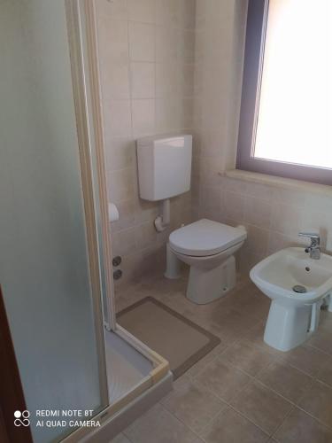 a bathroom with a toilet and a sink at Ai Gelsi in Lavariano