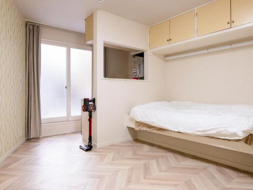 a bedroom with a bed and a floor vacuum at lol 2 105 in Hakodate