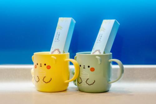 two coffee mugs withutes in them sitting on a counter at Holiday Inn Express Chengdu Wuhou by IHG-Wuhou Temple and Jinli in Chengdu