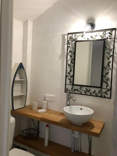 a bathroom with a sink and a mirror at MAISON, PROCHE UZES avec JARDIN ET TERRAIN DE BOULES in Foissac