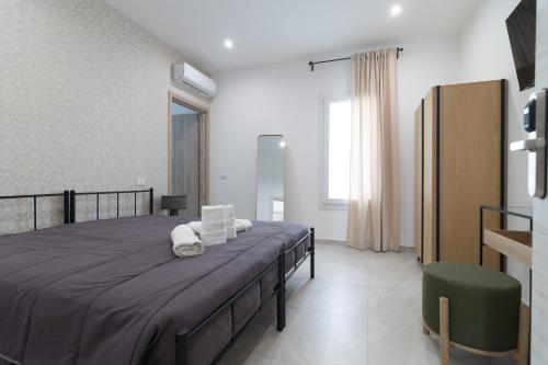 a bedroom with a large bed with two pillows on it at Residenze Miao in Montalto di Castro