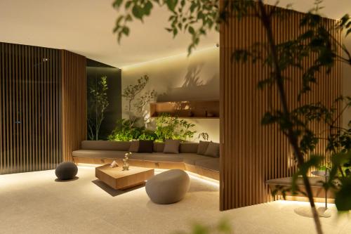 a living room with a couch and a table at The Yard Boutique Hotel Shanghai 一隅酒店上海虹桥漕河泾店 in Shanghai