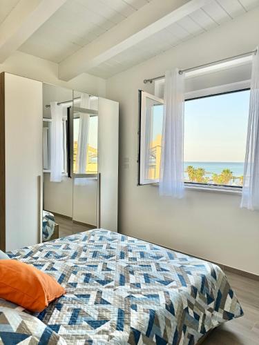 a bedroom with a bed with a view of the ocean at Vera Hotel in Porto San Giorgio