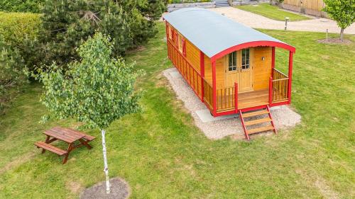 an overhead view of a tiny house and a picnic table at La Rouge Roulotte in Hassocks