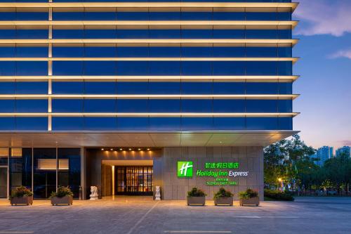 a building with a sign in front of it at Holiday Inn Express Suzhou East Taihu by IHG in Suzhou