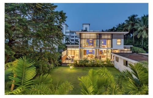 a large house with a lot of windows at Dia Hotels and Homes Nerul Goa - Villas and Apartments in Nerul