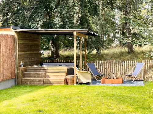 a gazebo with two chairs and a table at La Parenthèse - Peaceful and family-friendly cottage in Bastogne in Bastogne