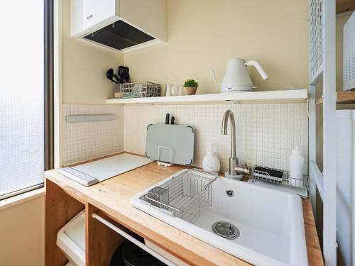 a kitchen with a sink and a counter top at お宿Ｇａｎ福田町-Luxury Stay-駐車場無料 in Takamatsu